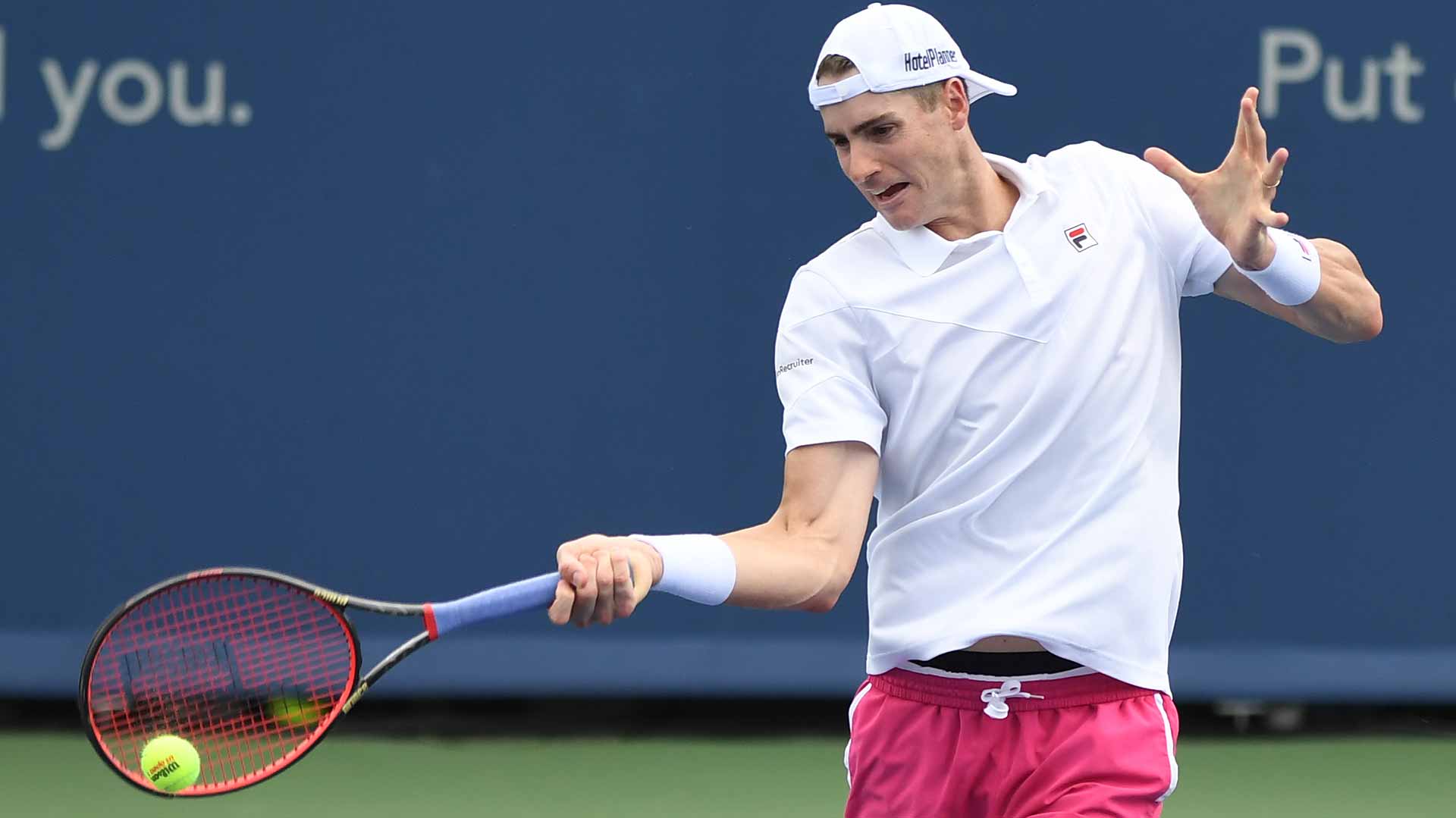 John Isner survives a third-set tie-break to advance past Benjamin Bonzi.