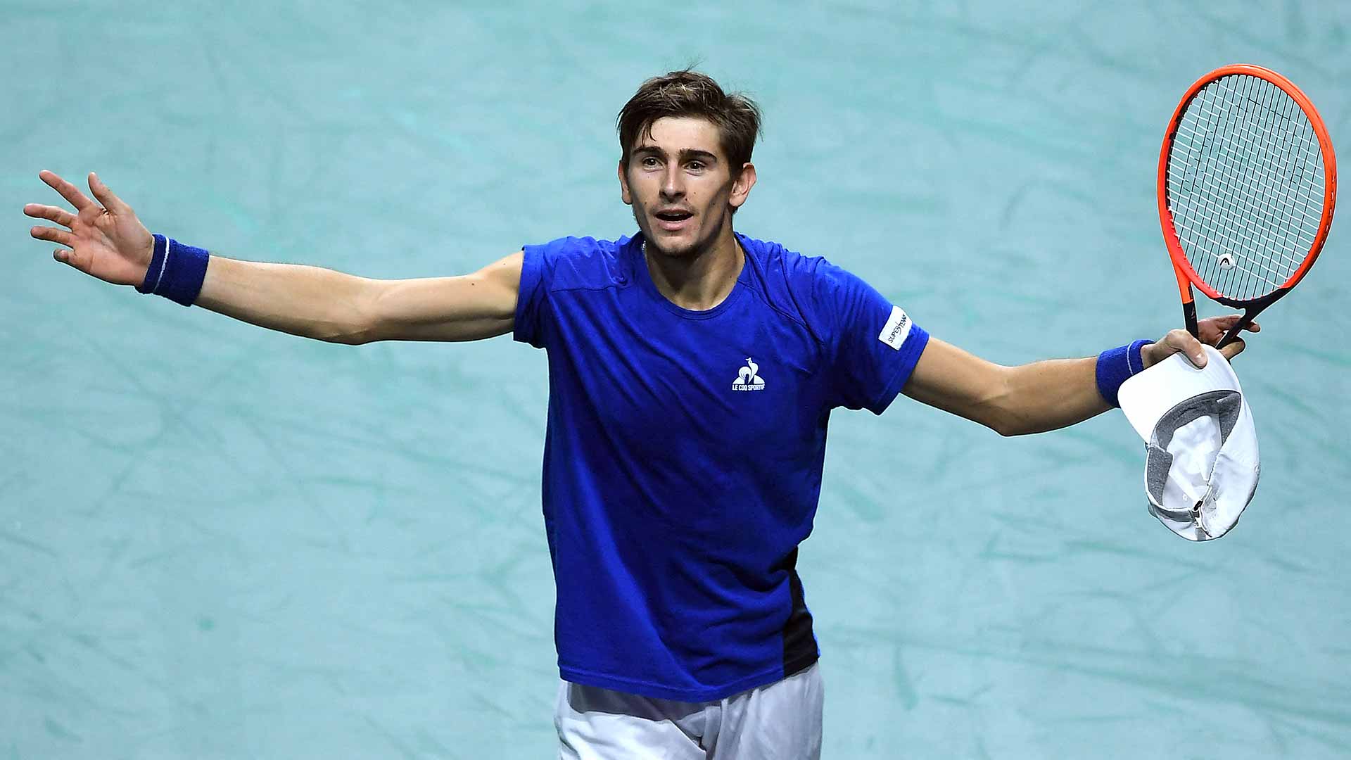 Matteo Arnaldi celebrates a three-set win over Alexei Popyrin in the Davis Cup final.