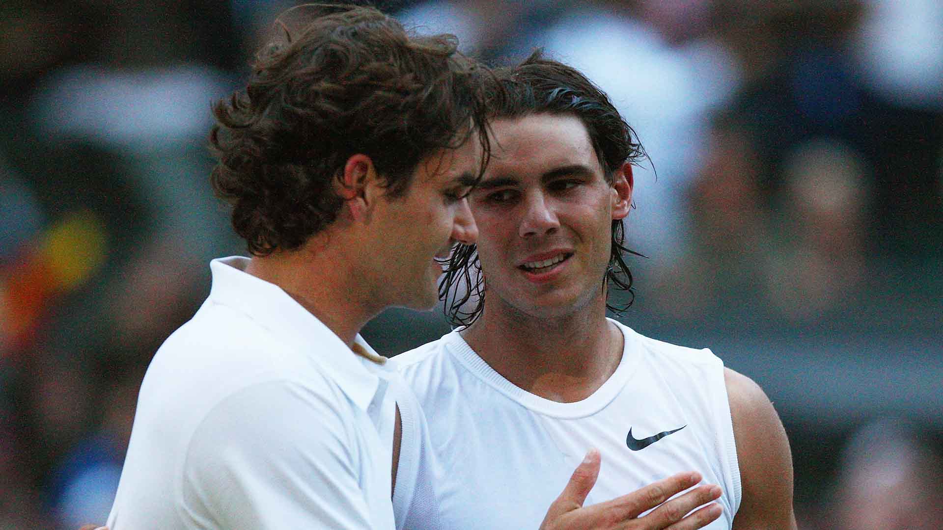 Roger Federer and Rafael Nadal share a moment at the net following the conclusion of the 2008 Wimbledon final.