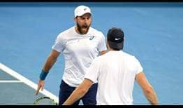 Steve Johnson, left, and Jack Sock celebrate forcing the quarter-final clash with Australia into a final day.