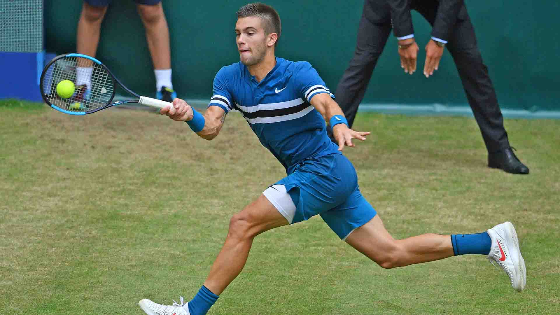 Borna Coric, who entered the week 2-7 in tour-level matches on grass, upsets Roger Federer to triumph in Halle.