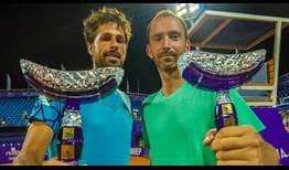Robin Haase and Matwe Middelkoop lift their third team trophies of the year in Umag.