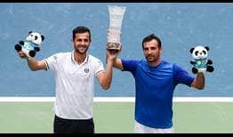 Mate Pavic and Ivan Dodig celebrate capturing their second team title on Sunday at the Chengdu Open.