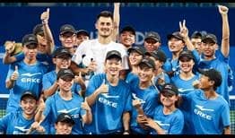 Bernard Tomic celebrates winning his fourth ATP World Tour title on Sunday at the Chengdu Open, where he saved four match points to beat Fabio Fognini.