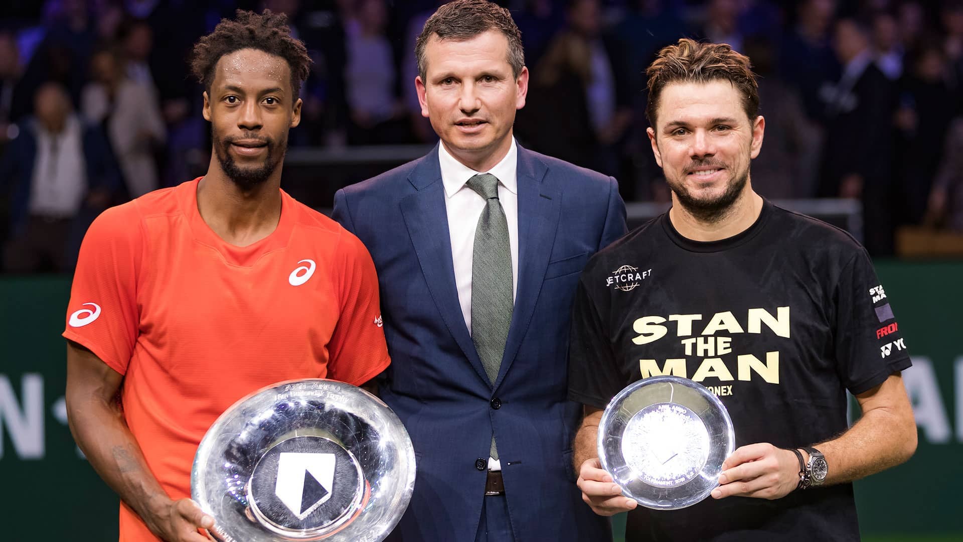 <a href='https://www.atptour.com/en/players/gael-monfils/mc65/overview'>Gael Monfils</a> beat <a href='https://www.atptour.com/en/players/stan-wawrinka/w367/overview'>Stan Wawrinka</a> (right) in the 2019 <a href='https://www.atptour.com/en/tournaments/rotterdam/407/overview'>ABN AMRO World Tennis Tournament</a> final. They pose for photos with Tournament Director <a href='https://www.atptour.com/en/players/richard-krajicek/k214/overview'>Richard Krajicek</a>.