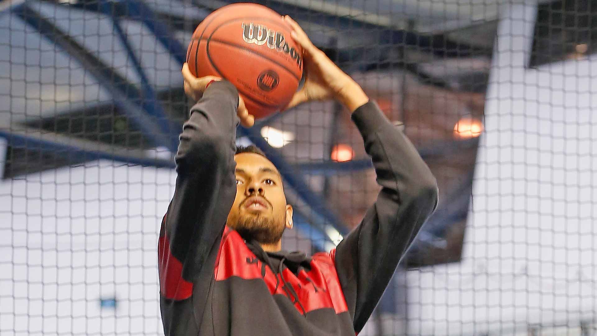 Nick Kyrgios shoots a basketball