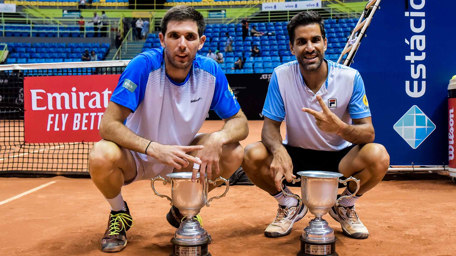 Federico Delbonis and Maximo Gonzalez hold their Brasil Open trophies.