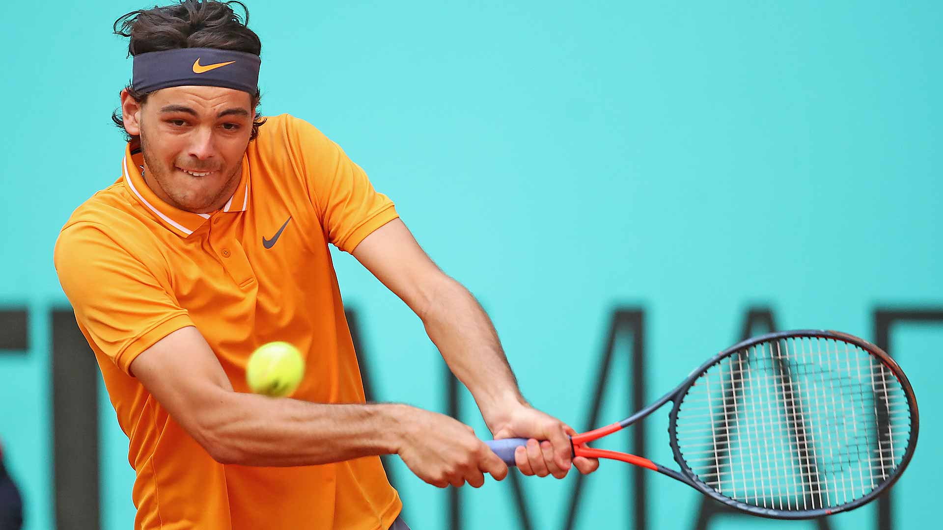 <a href='https://www.atptour.com/en/players/taylor-fritz/fb98/overview'>Taylor Fritz</a> hits a backhand in Madrid