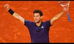 Dominic Thiem celebrates beating Roger Federer in Madrid on Friday after saving two match points in the second set tie-break.