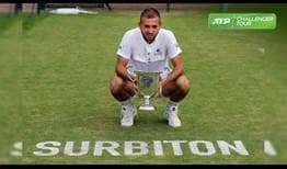 Daniel Evans lifts his first grass-court trophy, prevailing at the ATP Challenger Tour event in Surbiton.