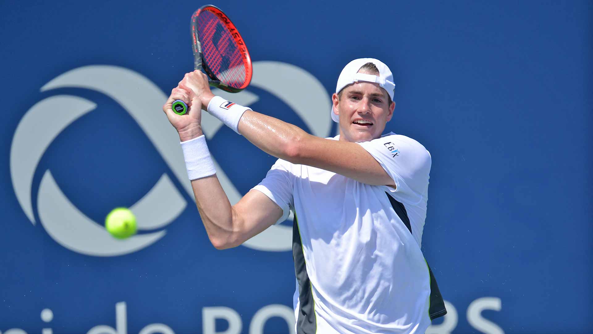 <a href='https://www.atptour.com/en/players/john-isner/i186/overview'>John Isner</a> hits a backhand in Montreal.