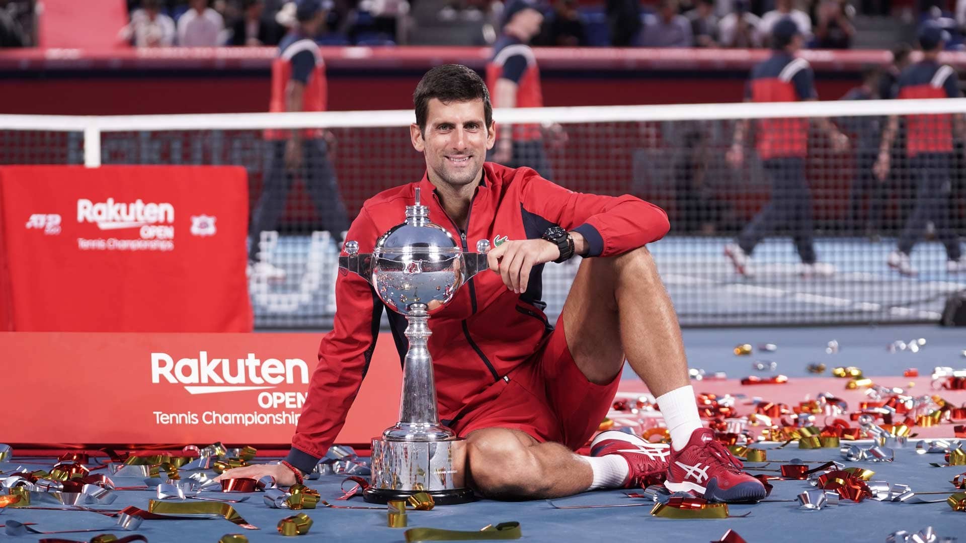 Novak Djokovic sits with the Tokyo 2019 trophy