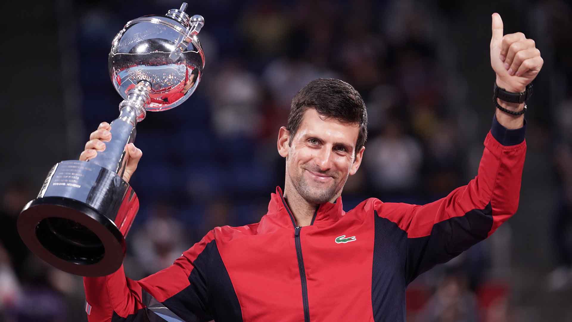 Novak Djokovic defeats John Millman in straight sets to lift the Rakuten Japan Open Tennis Championships trophy on Sunday.