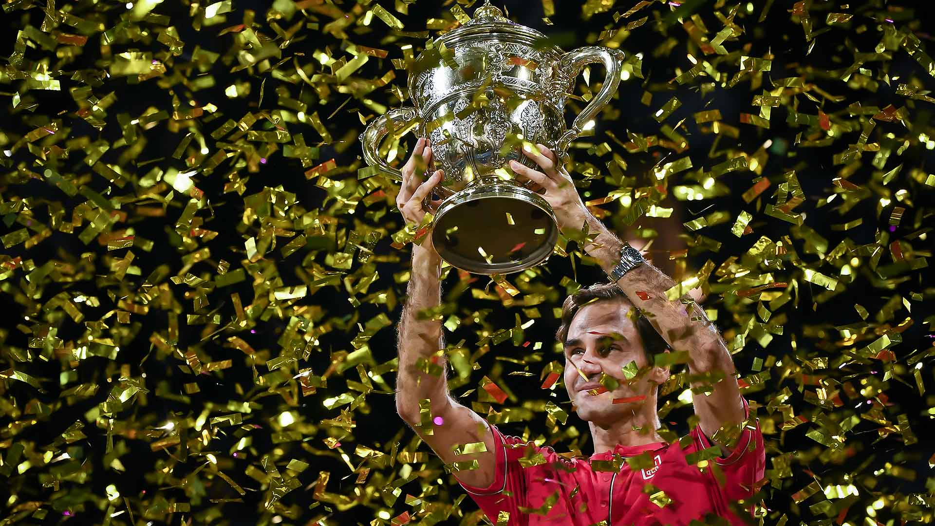 Roger Federer celebrates winning his 10th Basel title