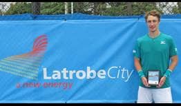Marc Polmans lifts the trophy in Traralgon, his third ATP Challenger Tour title.