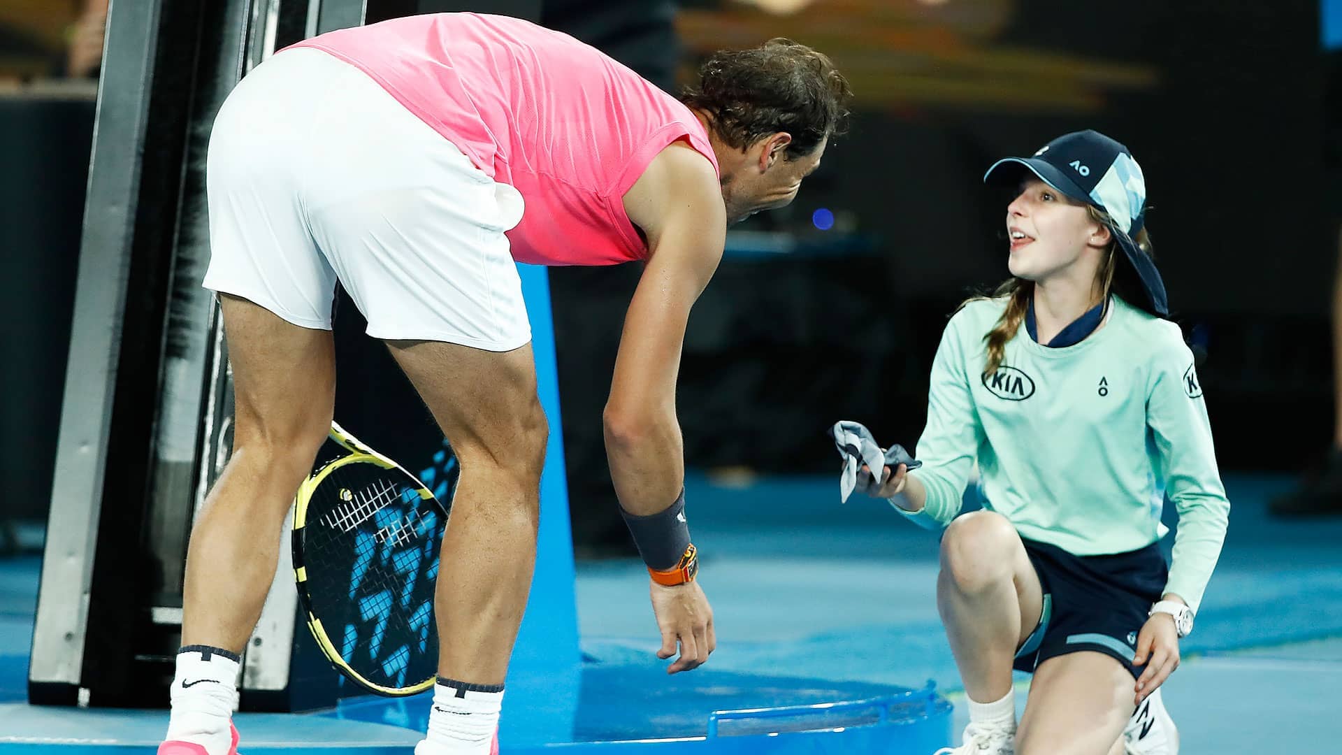 Rafael Nadal hands a ball girl his headband on Thursday after his Australian Open victory over Federico Delbonis.