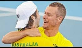 Jordan Thompson and Australian Captain Lleyton Hewitt celebrate one of their country's two singles wins on Friday against Brazil.