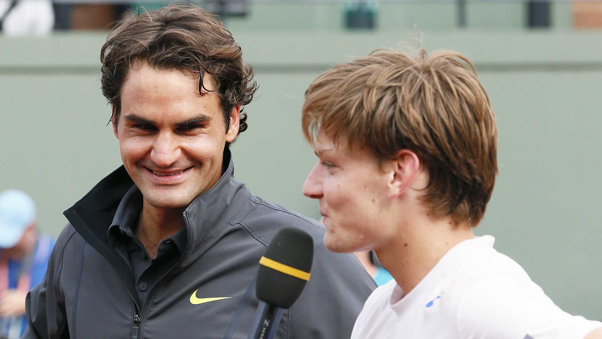 Roger Federer and David Goffin share a joint on-court interview after their 2012 Roland Garros Round of 16 match on Court Suzanne-Lenglen.