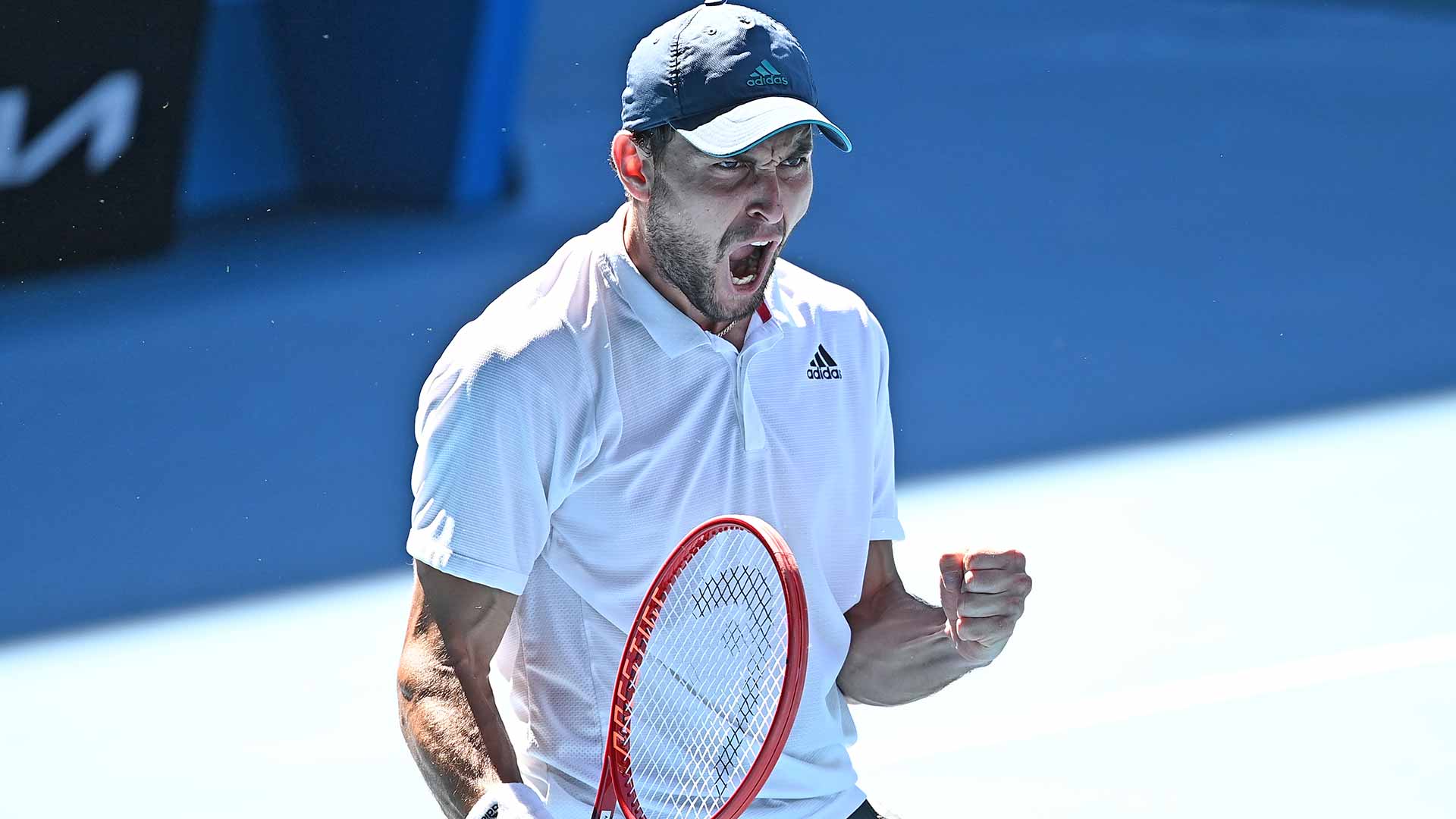 Aslan Karatsev celebrates completing a remarkable comeback against Felix Auger-Aliassime on Sunday at the Australian Open.