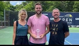 Jack Sock celebrates his first title since 2017 at the ATP Challenger Tour event in Little Rock, alongside wife Laura and coach Alex Bogomolov, Jr.