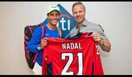 Rafael Nadal accepts a customised Washington Capitals jersey from one of the team's stars, Lars Eller.