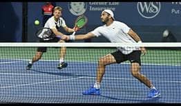 Kevin Krawietz and Horia Tecau advance to the second round in Cincinnati with a straight-sets win against Federico Delbonis and Diego Schwartzman.