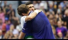 Novak Djokovic and Daniil Medvedev hug after the Russian defeats the World No. 1 to win his first major title at the US Open. 