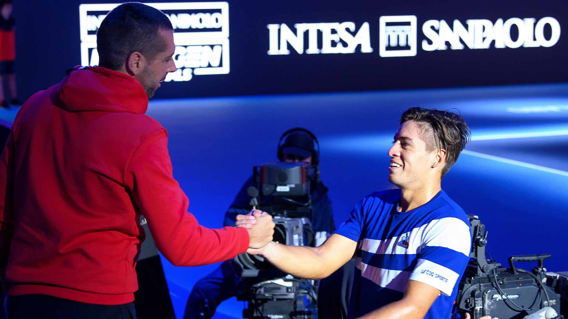 Coach Sebastian Gutierrez embraces Sebastian Baez following the 20-year-old's victory against Lorenzo Musetti on Tuesday in Milan. 