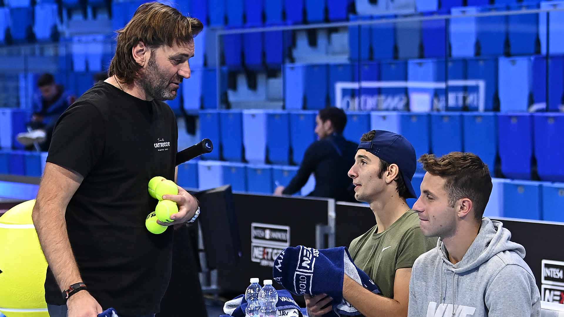 Coach Simone Tartarini oversees a practice session with Lorenzo Musetti (centre) at the Intesa Sanpaolo Next Gen ATP Finals.