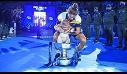 Pierre-Hugues Herbert celebrates winning the title in Turin with his baby. 