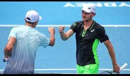 David Goffin [right] bumps fists with Facundo Bagnis [left] after his victory on Monday in Sydney. 