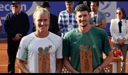 Rafael Matos and David Vega Hernandez lift their Marrakech trophies after a straight-sets final victory.