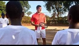 Roger Federer visits with kids at the Malawi Tennis Association during his trip to the African country.