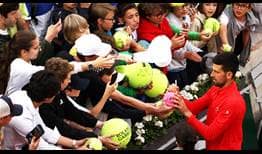 Novak Djokovic signs autographs after his second-round win at Roland Garros.
