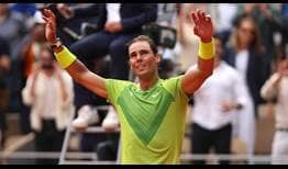 An emotional Rafael Nadal lifts his arms after winning a 14th Roland Garros title.