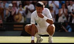 Novak Djokovic eats the grass on Centre Court after winning his seventh Wimbledon crown.