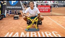 Lorenzo Musetti celebrates his first ATP Tour title after defeating Carlos Alcaraz in a three-set thriller on Sunday in Hamburg.