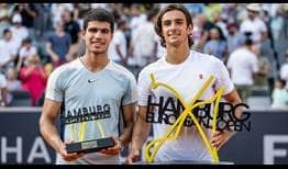 Carlos Alcaraz and Lorenzo Musetti pose with their trophies after Musetti won a three-set thriller on Sunday in the Hamburg final.