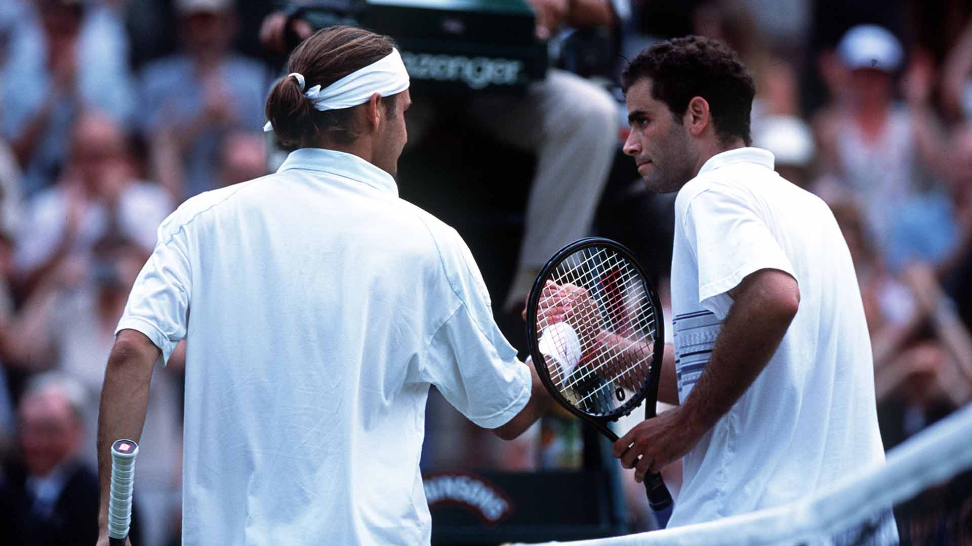 <a href='https://www.atptour.com/en/players/roger-federer/f324/overview'>Roger Federer</a> (left) and <a href='https://www.atptour.com/en/players/pete-sampras/s402/overview'>Pete Sampras</a> embrace at the net following their match at <a href='https://www.atptour.com/en/tournaments/wimbledon/540/overview'>Wimbledon</a> in 2001.