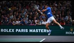 Novak Djokovic jumps into a backhand during his third-round victory against Karen Khachanov at the Rolex Paris Masters on Thursday.