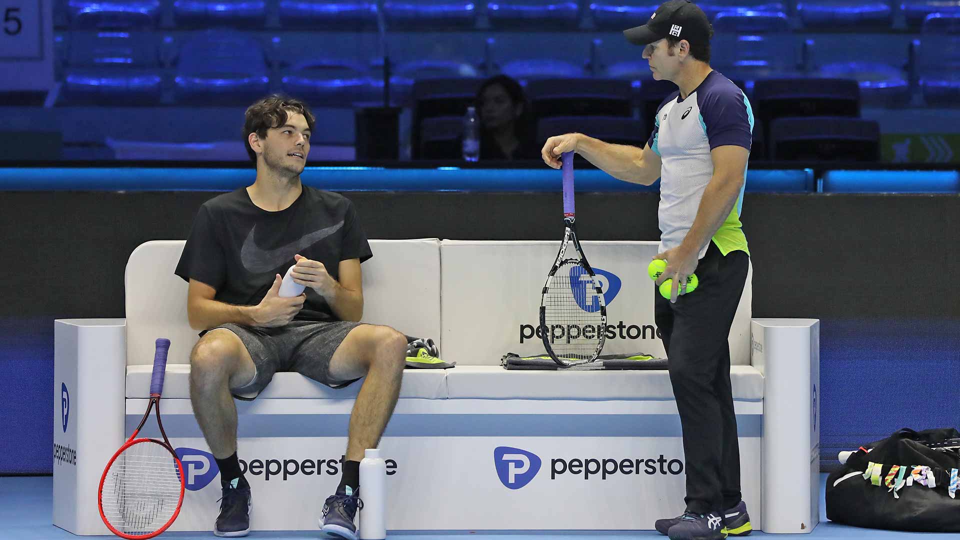 Taylor Fritz and Michael Russell chat during practice at the Pala Alpitour.