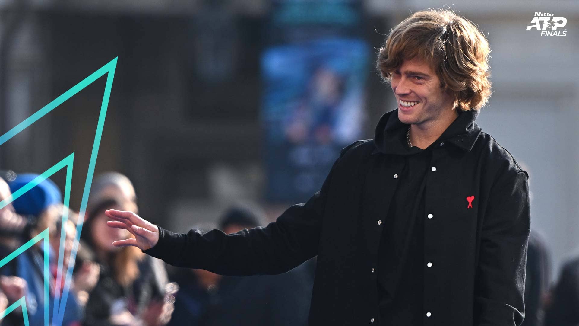 Andrey Rublev waves to fans on Turin's Piazza San Carlo.