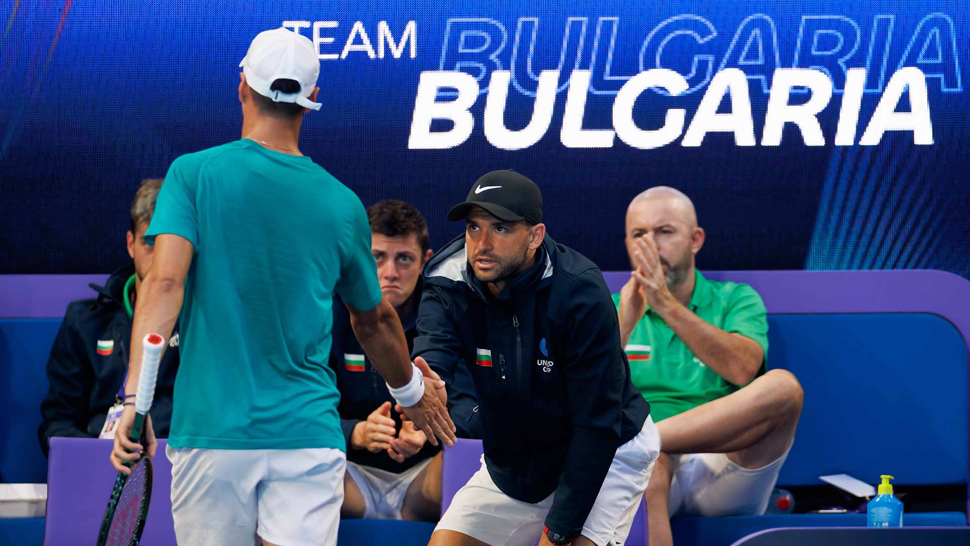 Grigor Dimitrov supports Dimitar Kuzmanov from the Team Bulgaria player box on Friday in Perth.