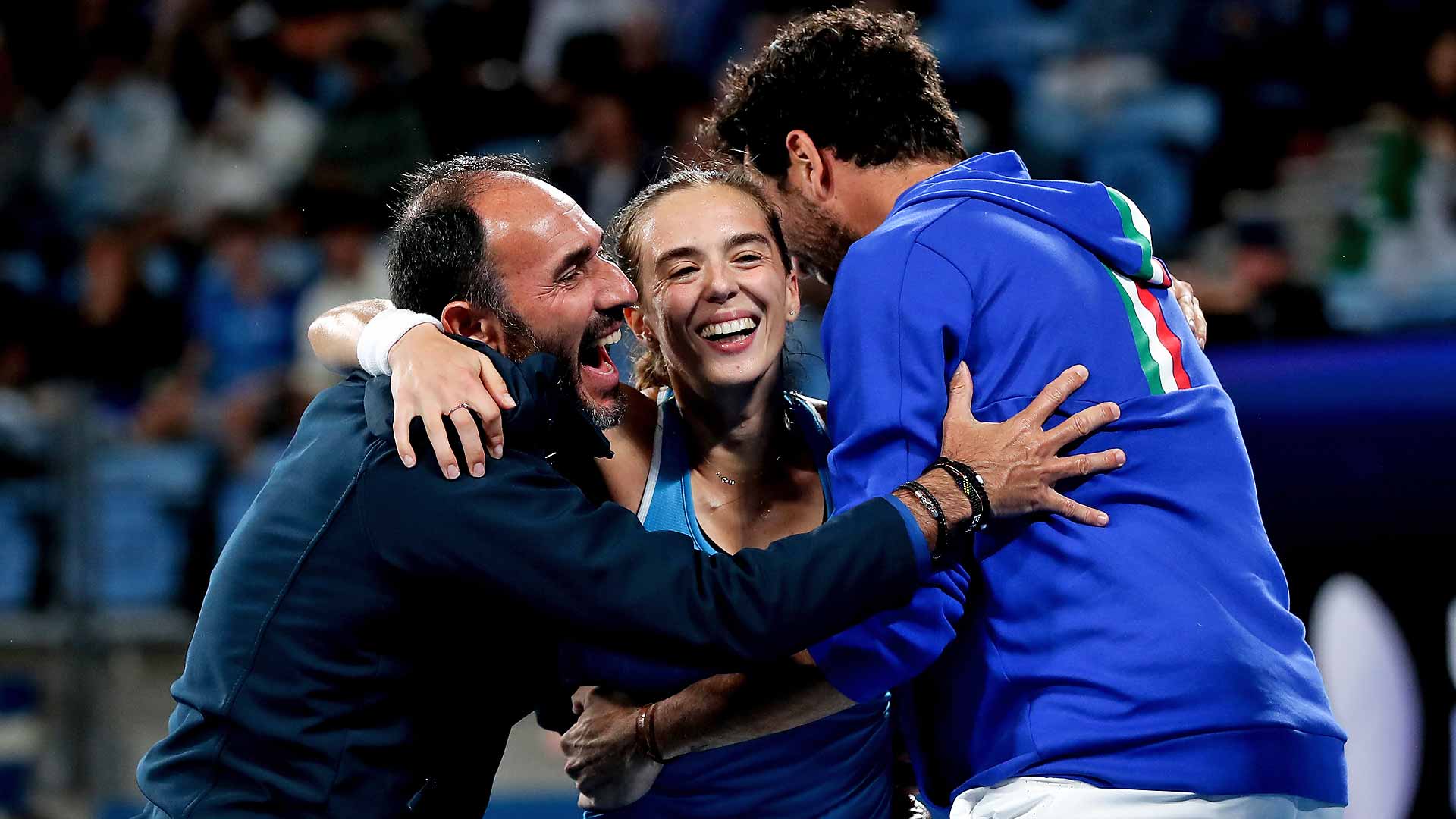 Captain Vincenzo Santopadre, Lucia Bronzetti and Matteo Berrettini celebrate Team Italy's victory over Team Greece in the United Cup Final Four.
