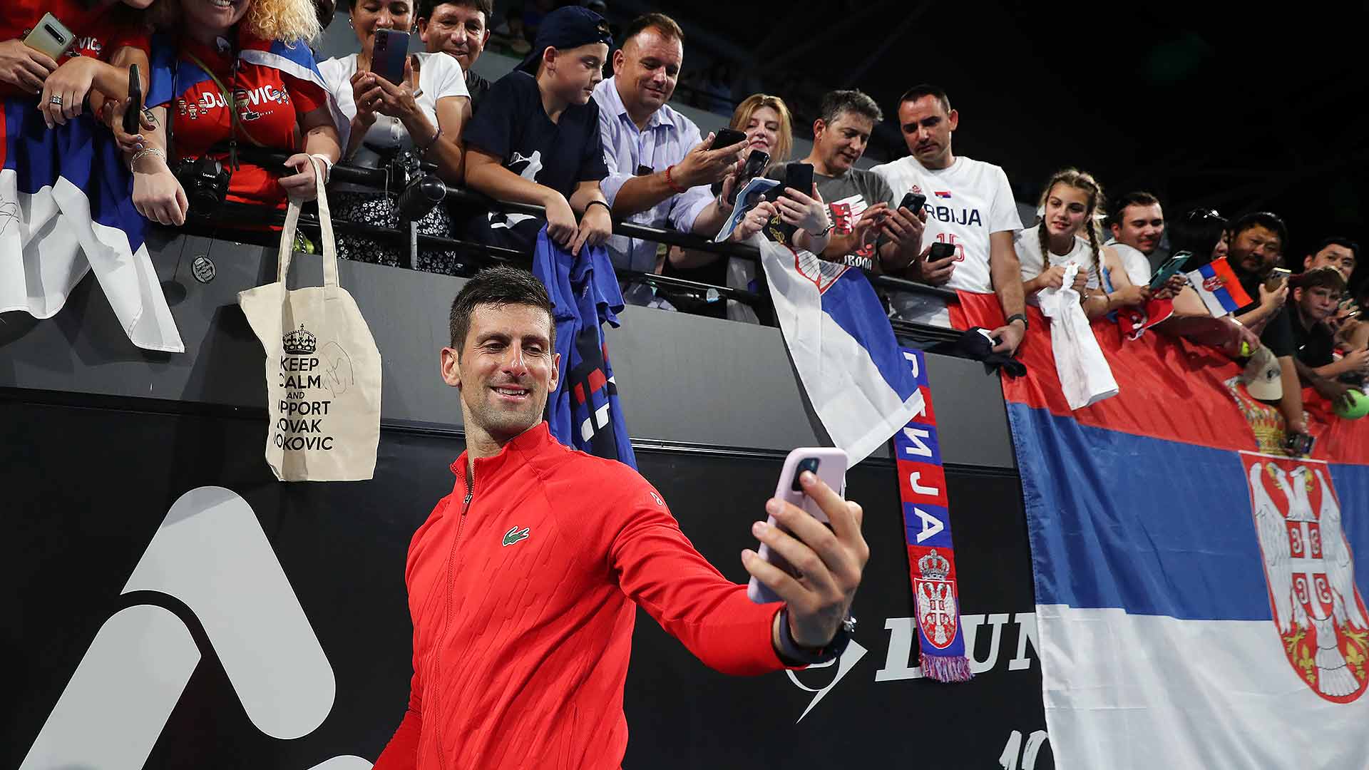Novak Djokovic celebrates his 92nd tour-level title with Serbian fans in Adelaide.
