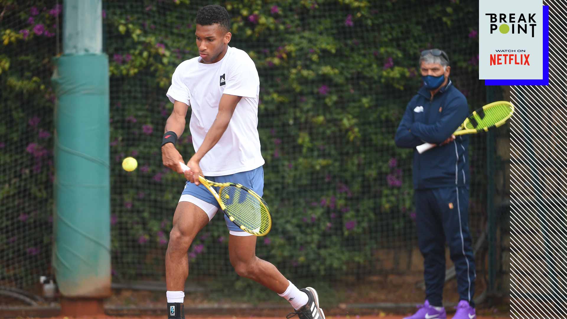 Felix Auger-Aliassime practises as coach Toni Nadal looks on. 