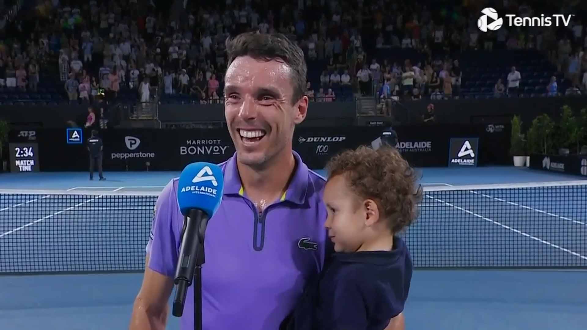 Roberto Bautista Agut shares a laugh with his son at the Adelaide International 2.