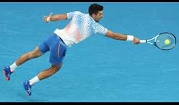 Novak Djokovic dives for a volley against Stefanos Tsitsipas on Sunday during the Australian Open final.