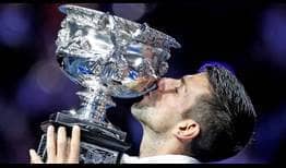 Novak Djokovic lifts the Norman Brookes Challenge Cup for a record-extending 10th time.