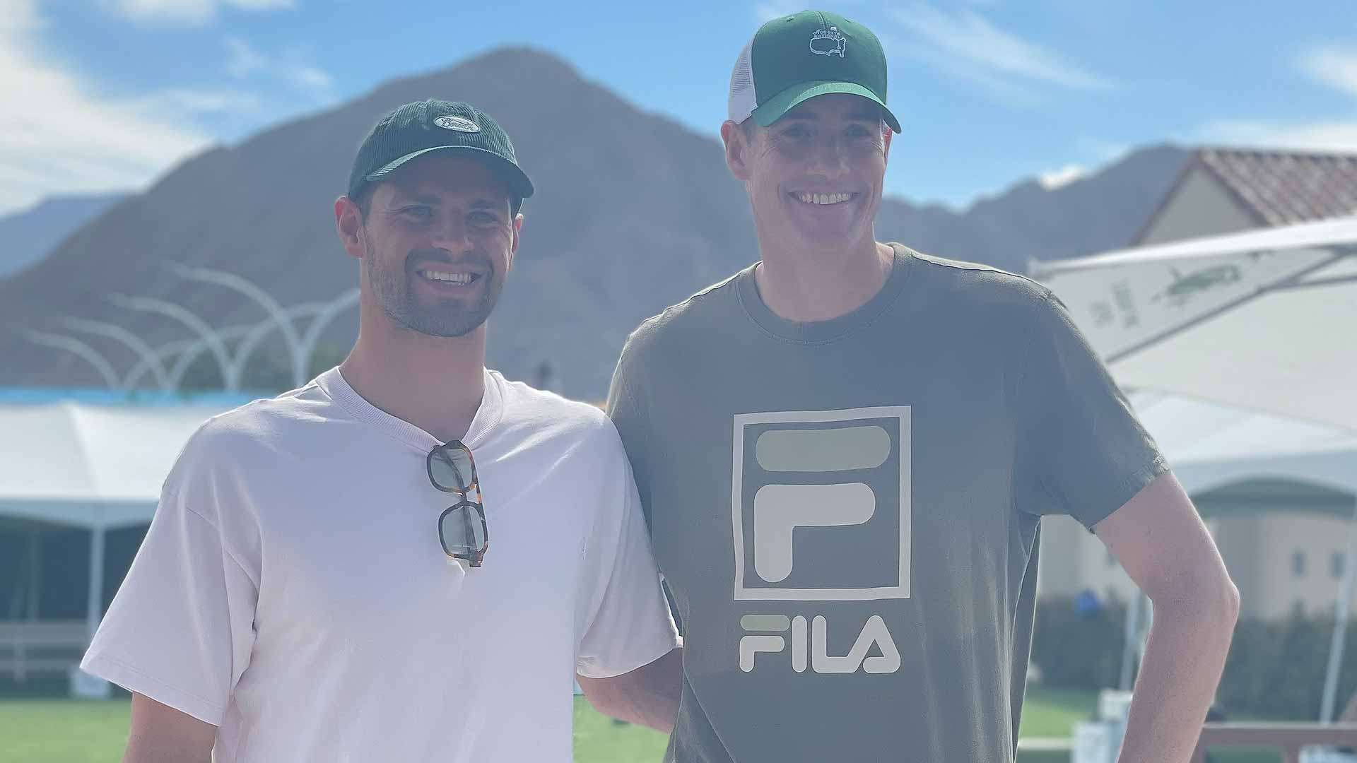 Olympic gold medalist Michael Andrew and John Isner pose for a photo at the Indian Wells Tennis Garden.